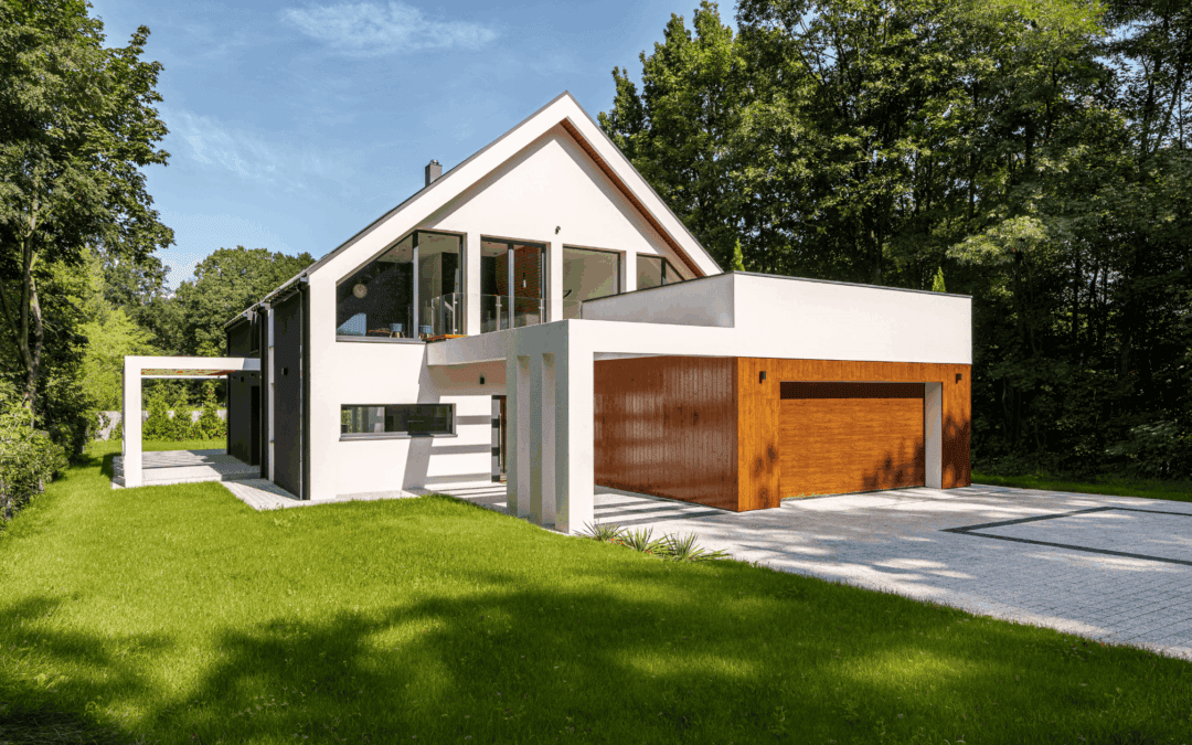 Contemporary house with white and wood accents, surrounded by lush greenery.