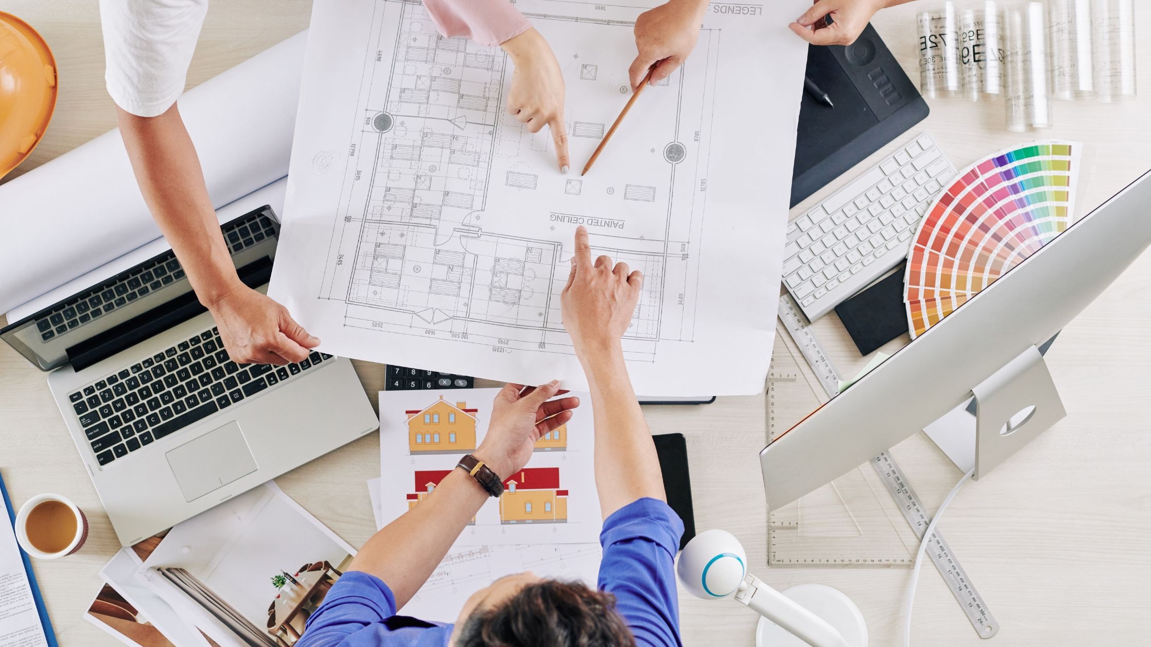 Architects reviewing blueprints for custom home construction project.