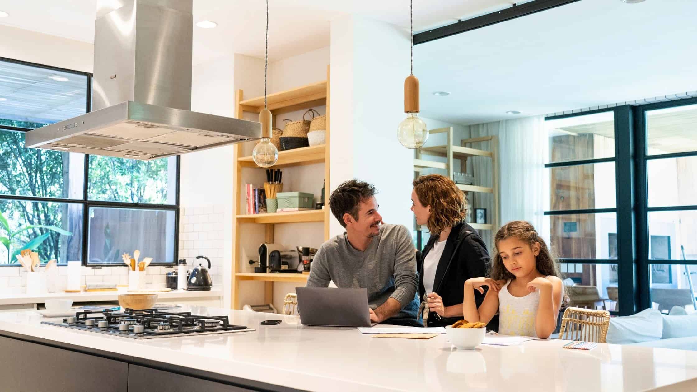 Bright, modern kitchen with family enjoying time together at the island.