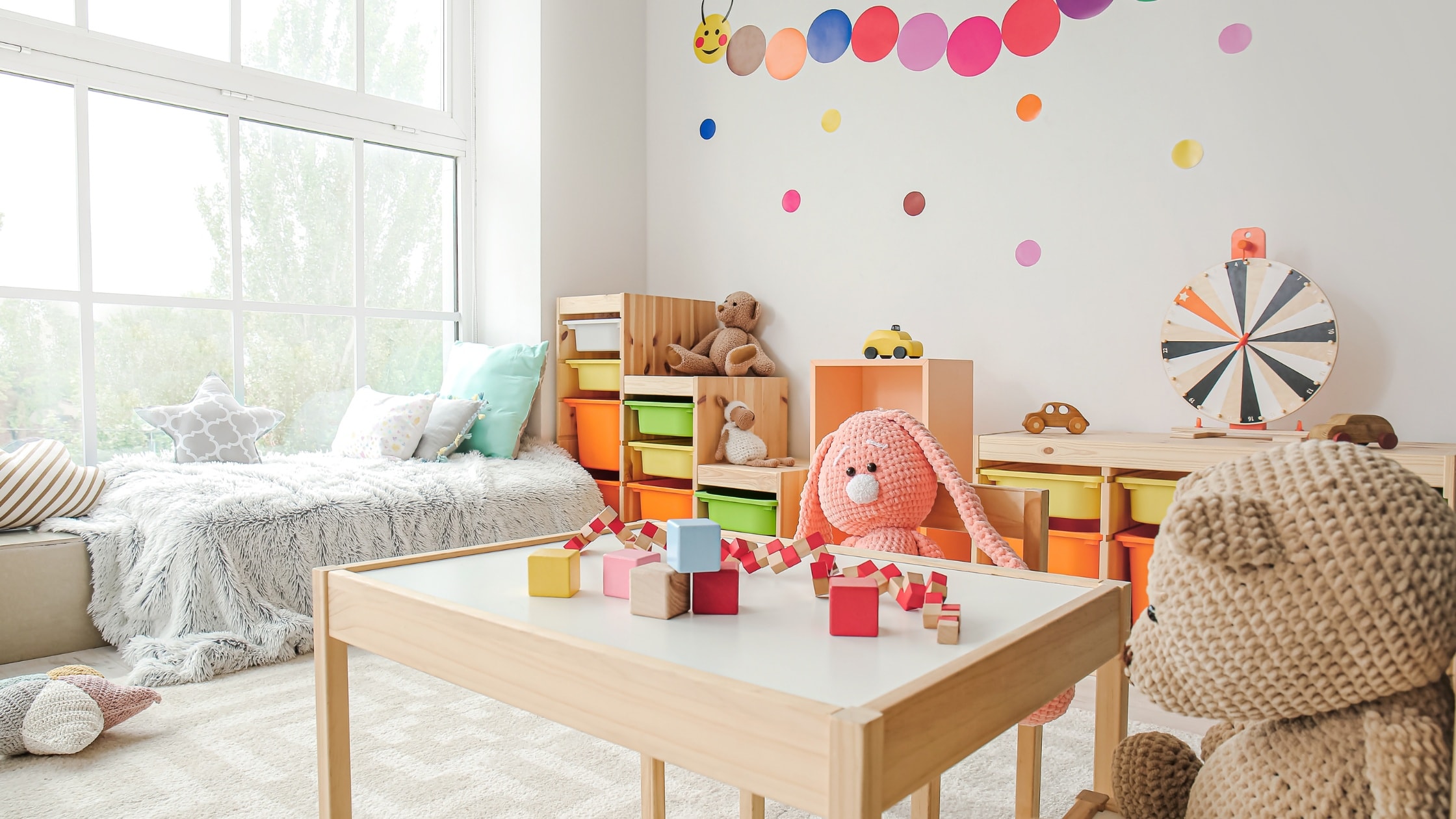Bright children's playroom with colorful toys and storage units for kids' activities.
