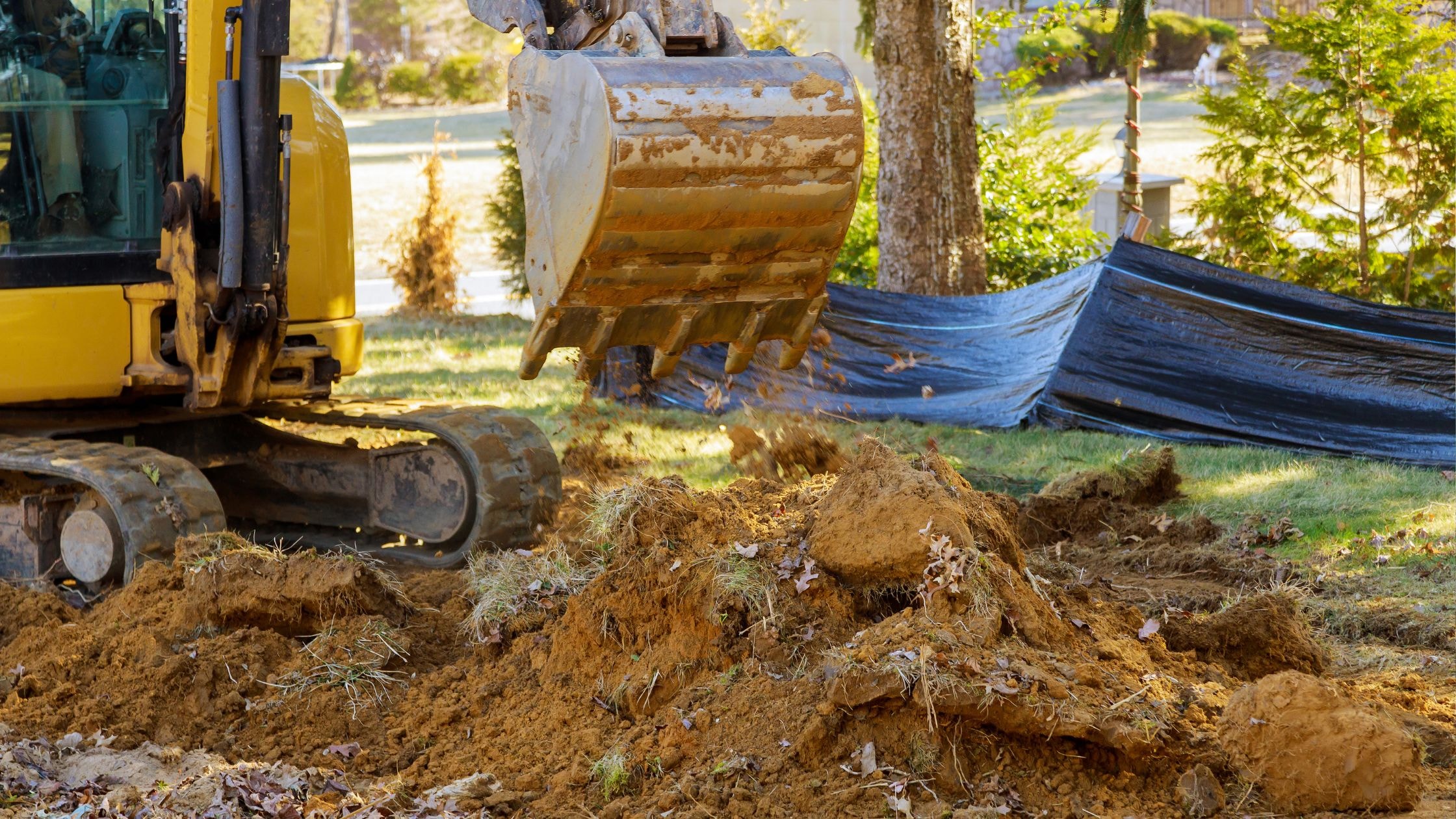 Excavation site with heavy machinery and dirt, showcasing construction work by Choate Builders.