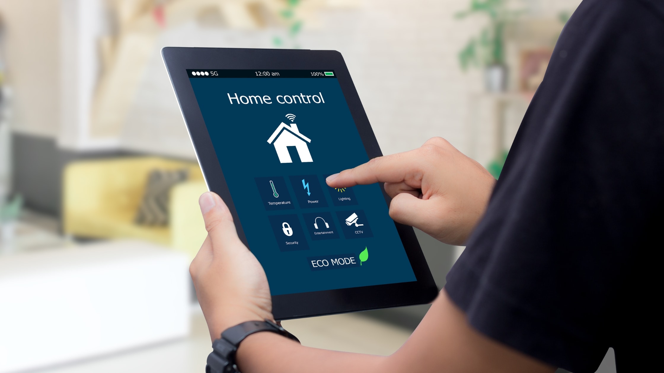 Person using a tablet to manage smart home features, including security and eco mode.