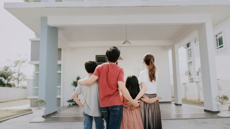 Family enjoying time together on the porch of a modern home.