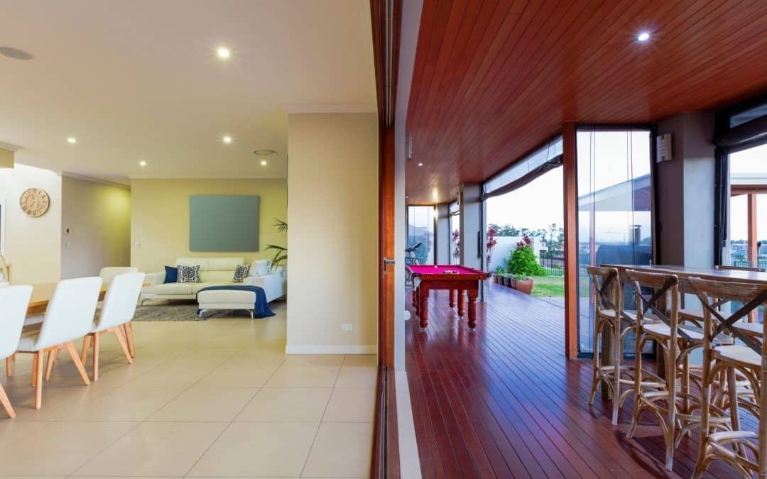 Bright, open-concept living room with large windows and modern furniture.
