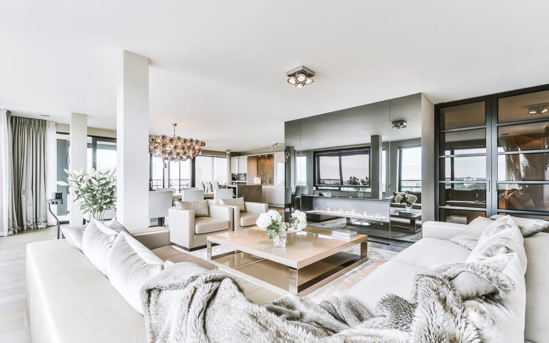 Bright and spacious modern living room with large windows, stylish furniture, and contemporary decor.