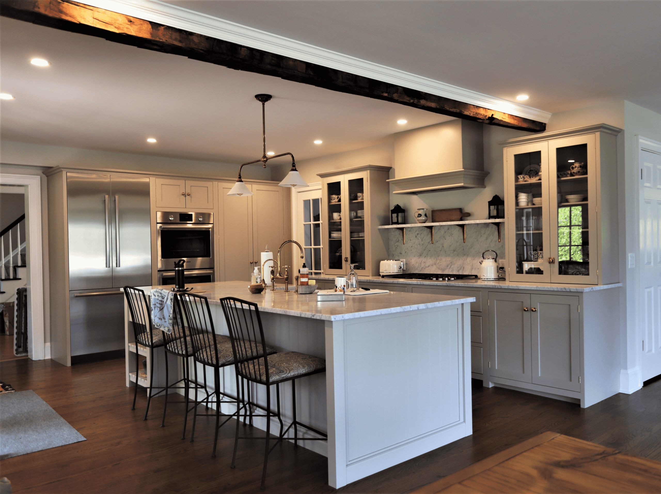 Modern kitchen with island, stainless steel appliances, and ample cabinetry for storage.