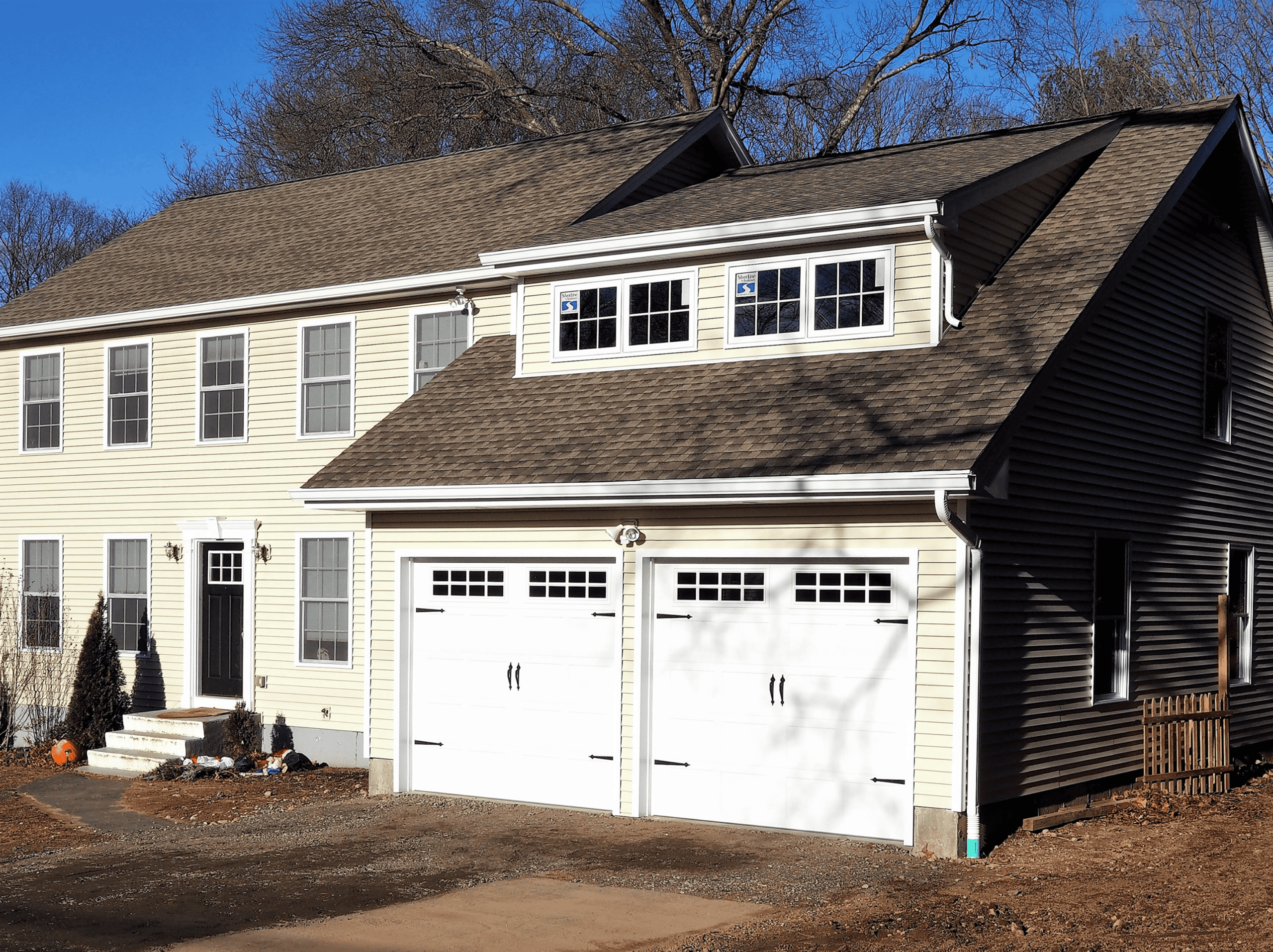 Modern residential home with attached garage and multiple windows.