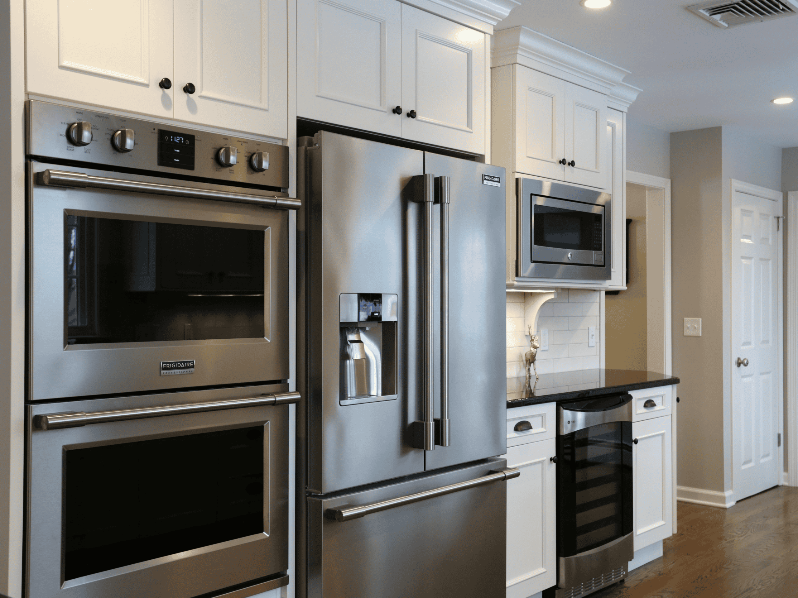 Modern stainless steel kitchen appliances including refrigerator, oven, and microwave.