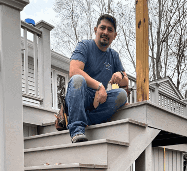 Skilled builder installing a new deck on a residential home.