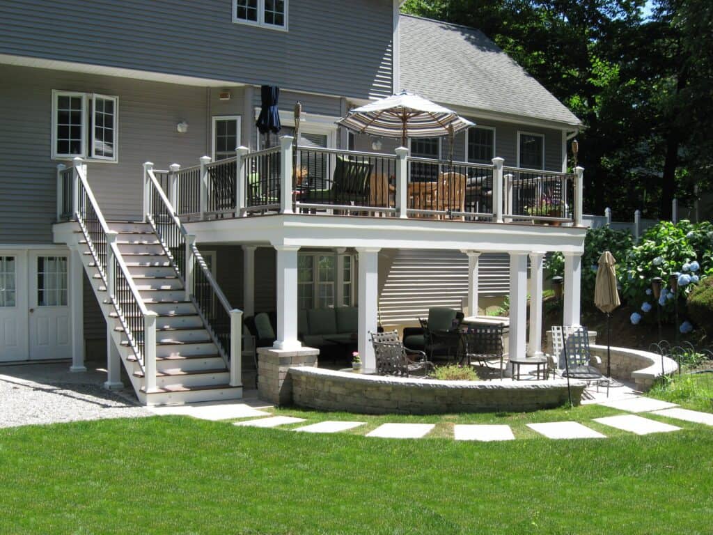 Deck extension with outdoor seating and umbrella.