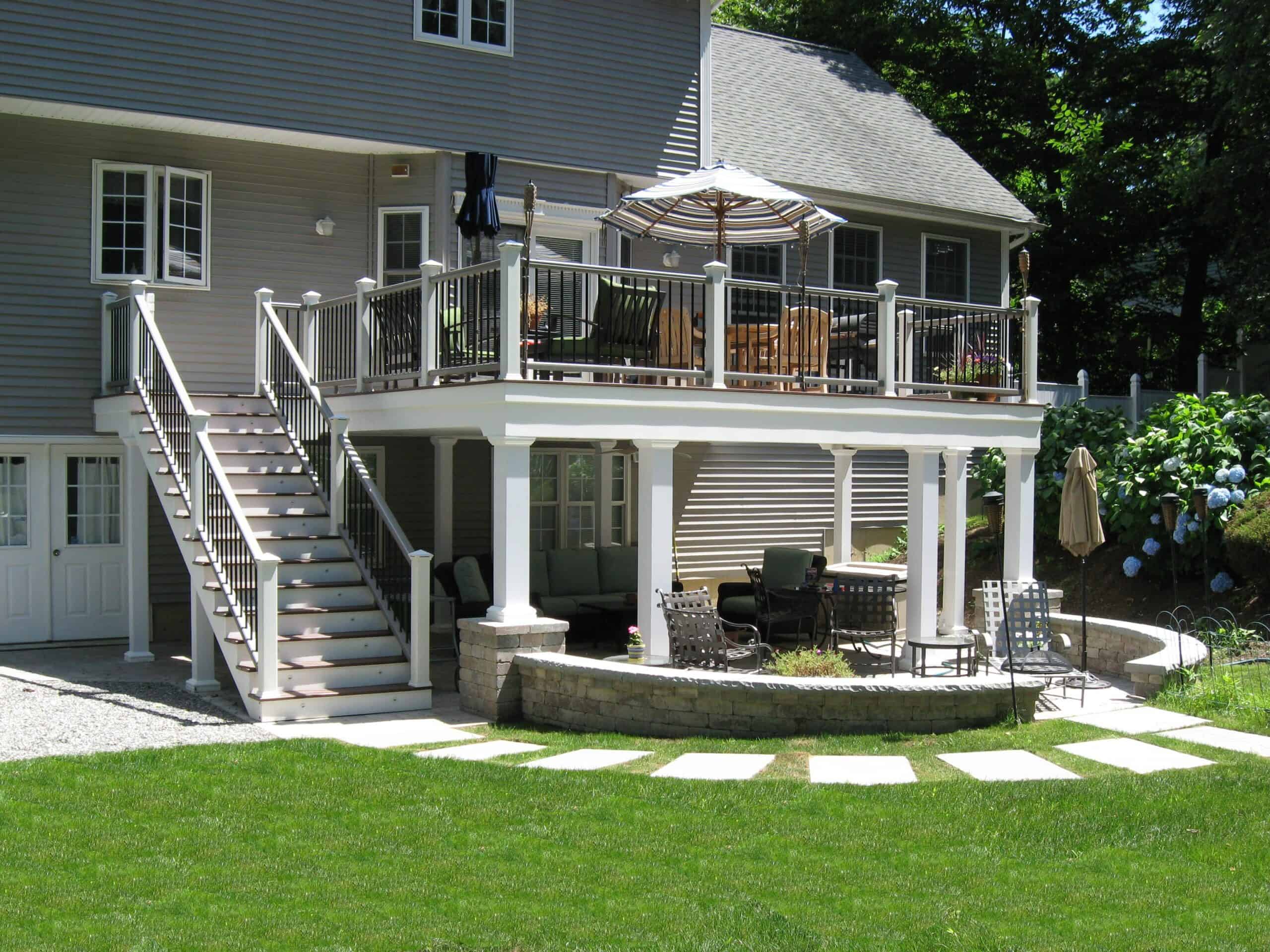 Deck extension with outdoor seating and umbrella.