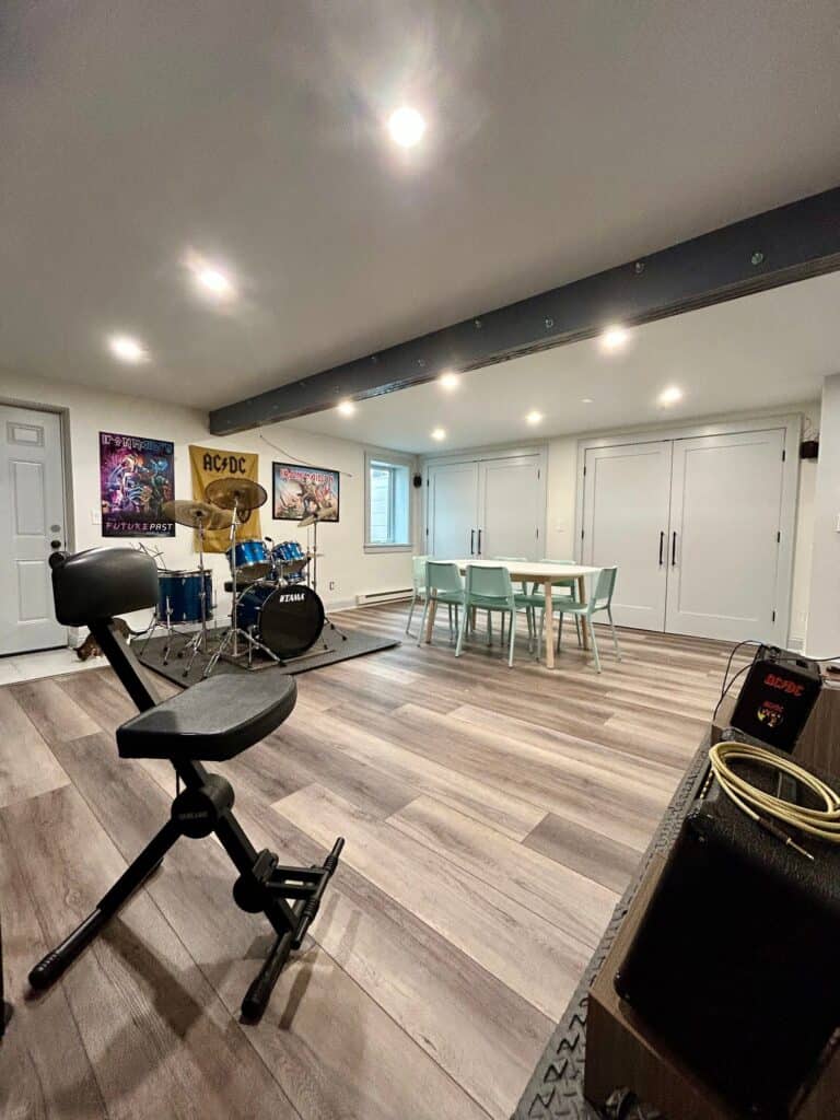 Spacious basement with music area, workout space, and dining table for family fun.
