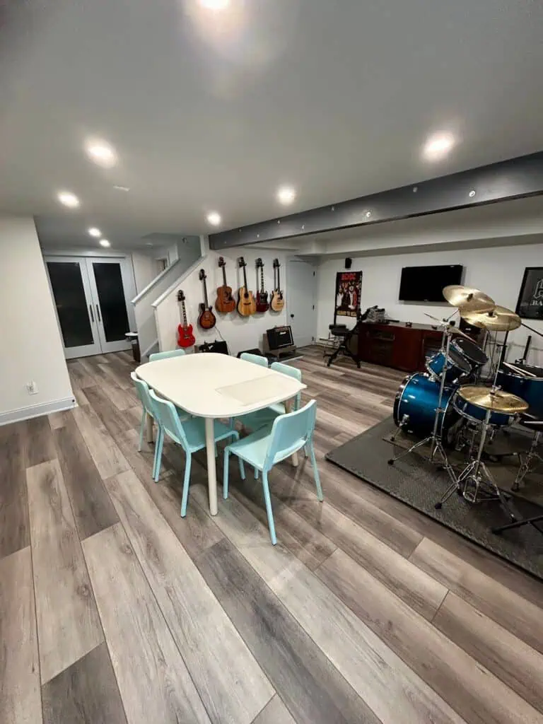 Music room with guitars, drums, and a cozy seating area.