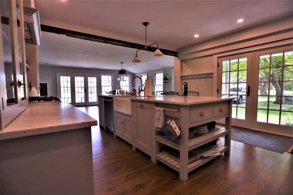 Modern kitchen with island and large windows.