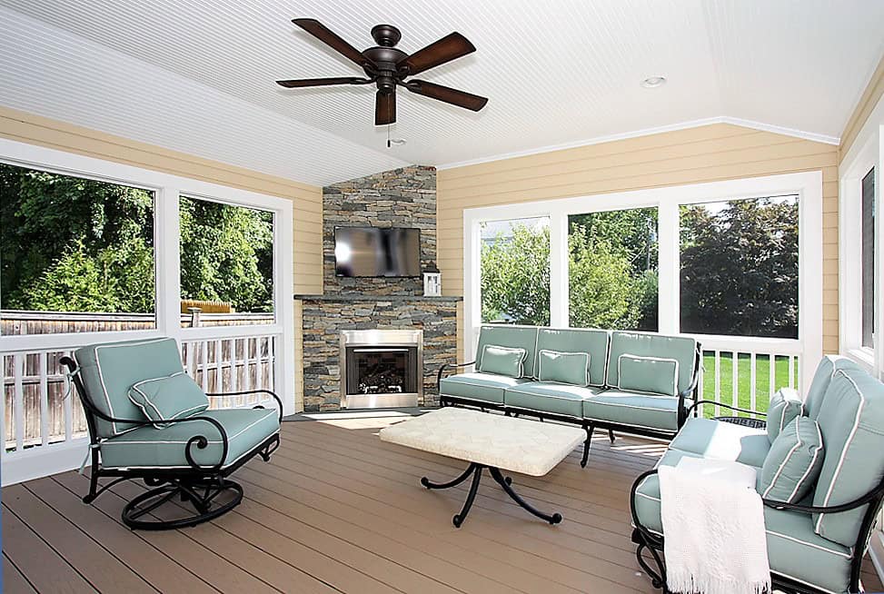 Sunroom with large windows and comfortable seating.