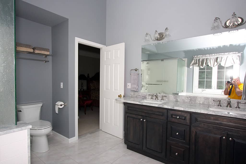 Modern bathroom with double vanity, large mirror, and updated fixtures.