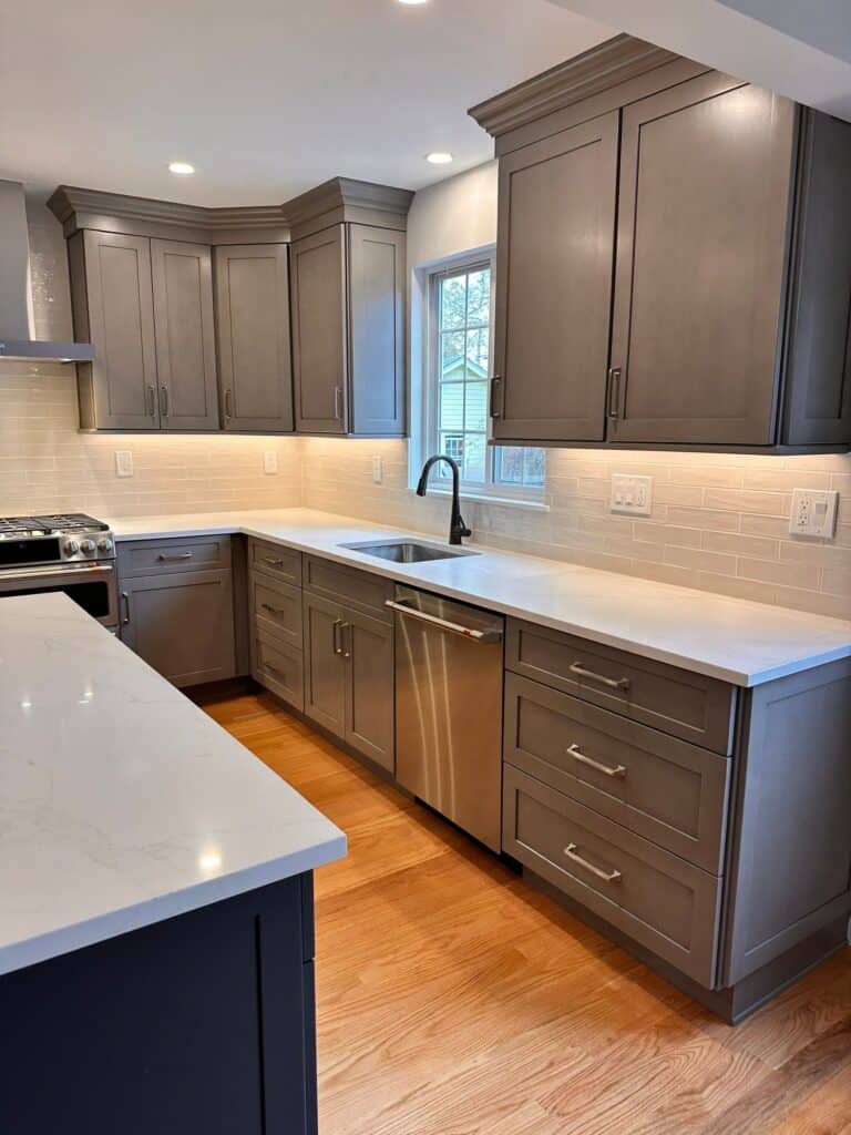 Kitchen cabinetry with sleek gray finish and stainless steel hardware.