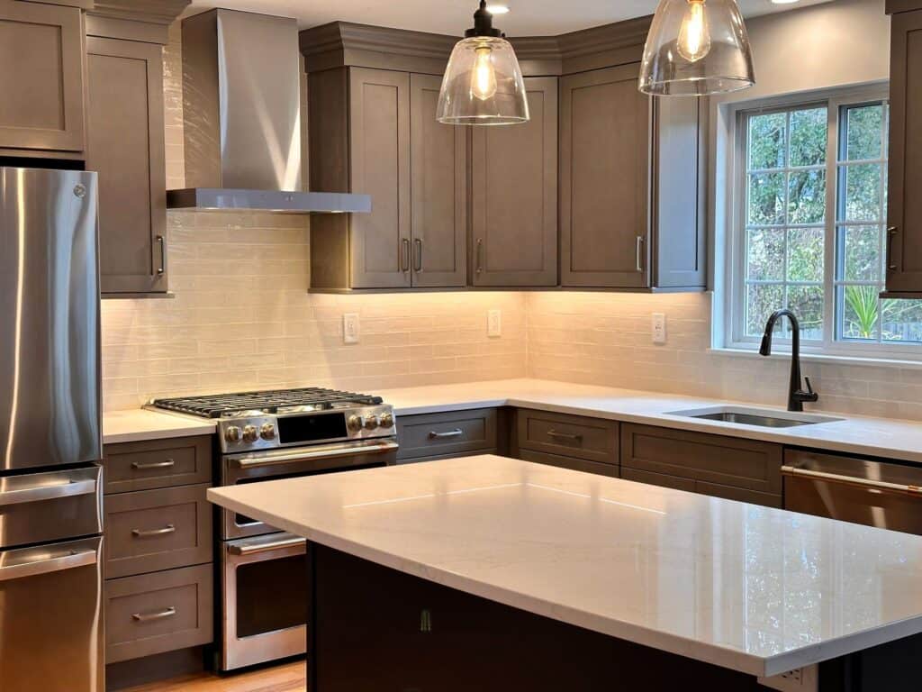 Kitchen with gray cabinets and stainless steel appliances.