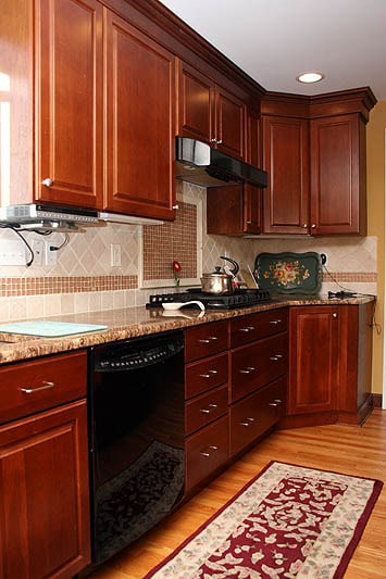 Beautiful kitchen with rich cherry wood cabinets and granite countertops.
