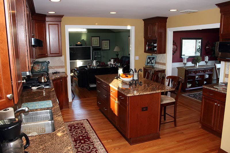 Modern kitchen with wooden cabinets and granite countertops.
