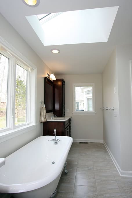 Bright bathroom featuring a skylight, bathtub, and natural light for a relaxing space.