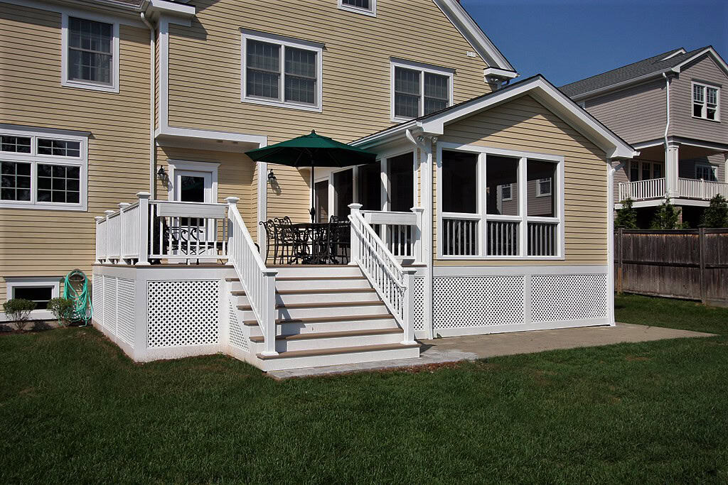 Deck extension with stairs and railing.