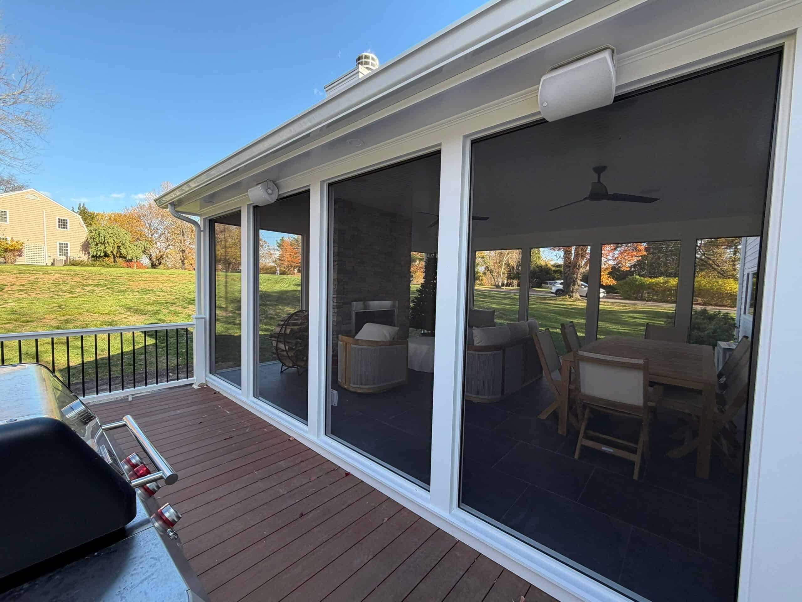 Sunroom with large glass sliding doors and outdoor deck.