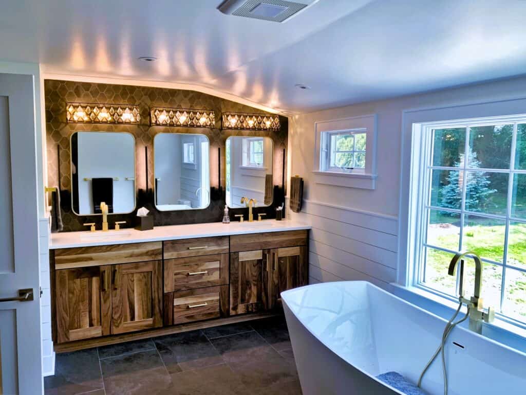 Elegant bathroom with double vanity and stylish mirrors.