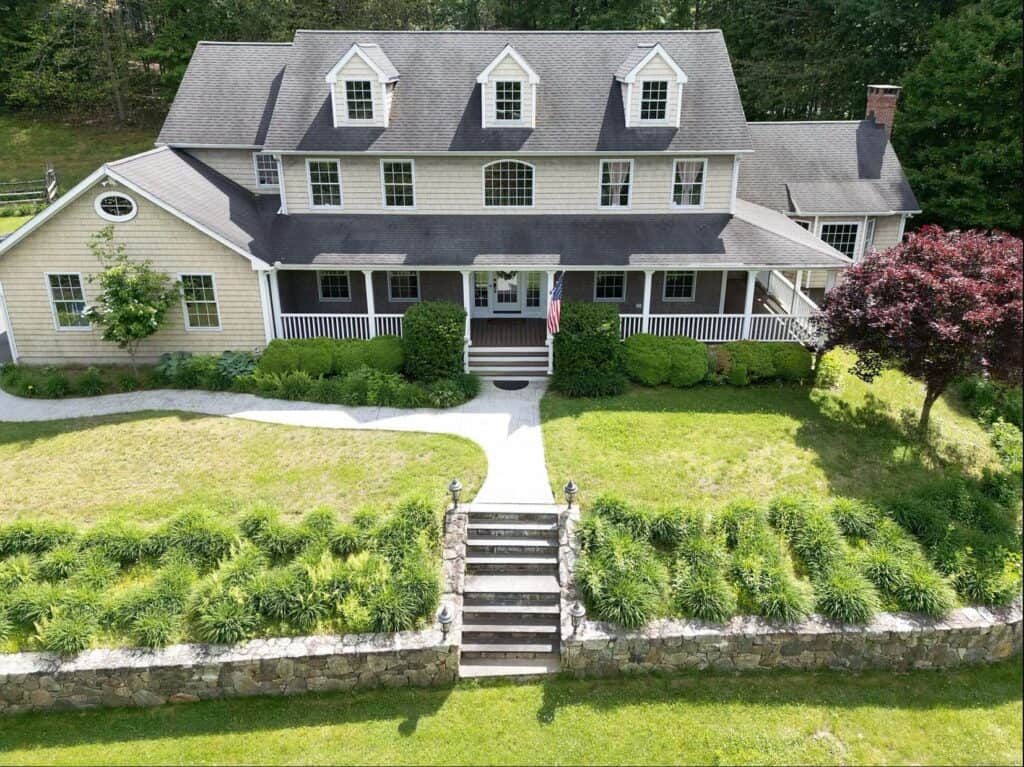 Beautifully landscaped house with a spacious porch and lush greenery. Perfect for family living and.