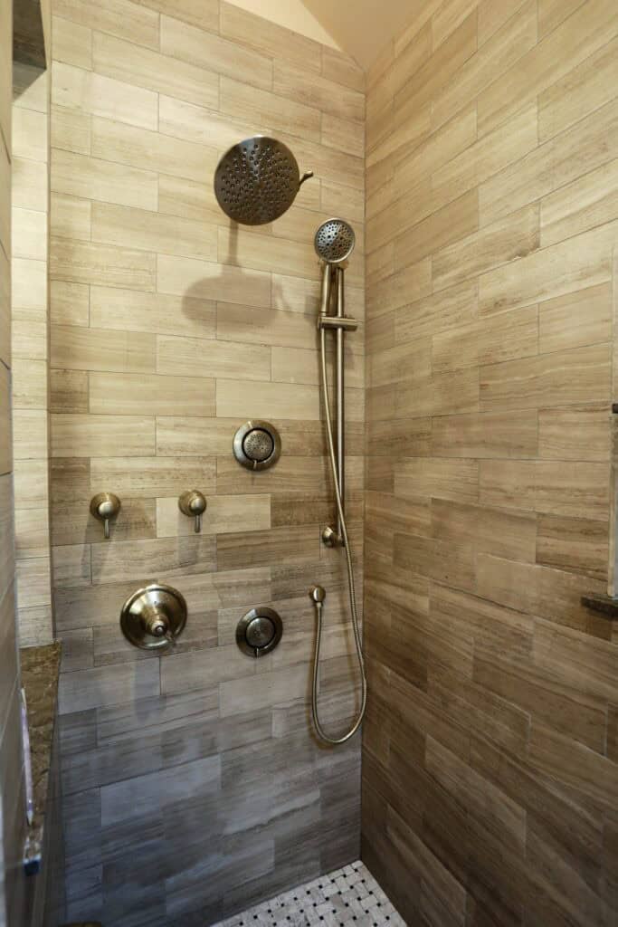 Modern shower with multiple showerheads and controls.