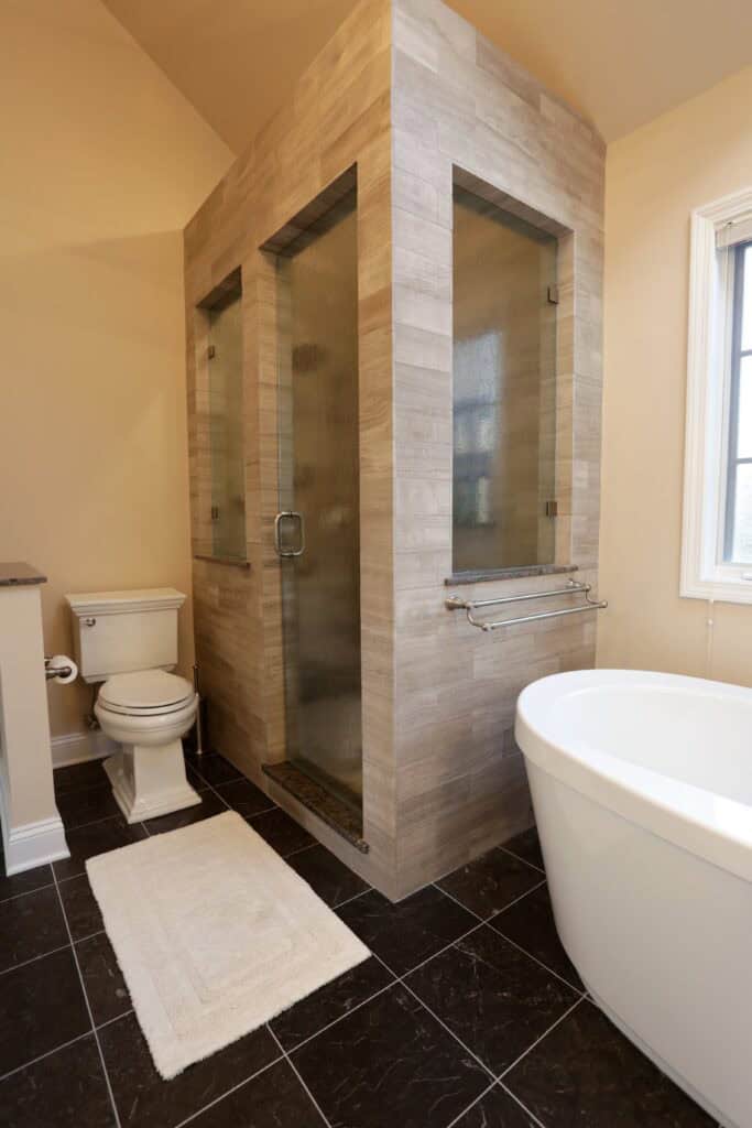 Shower enclosure with glass doors and tiled walls in a contemporary bathroom.