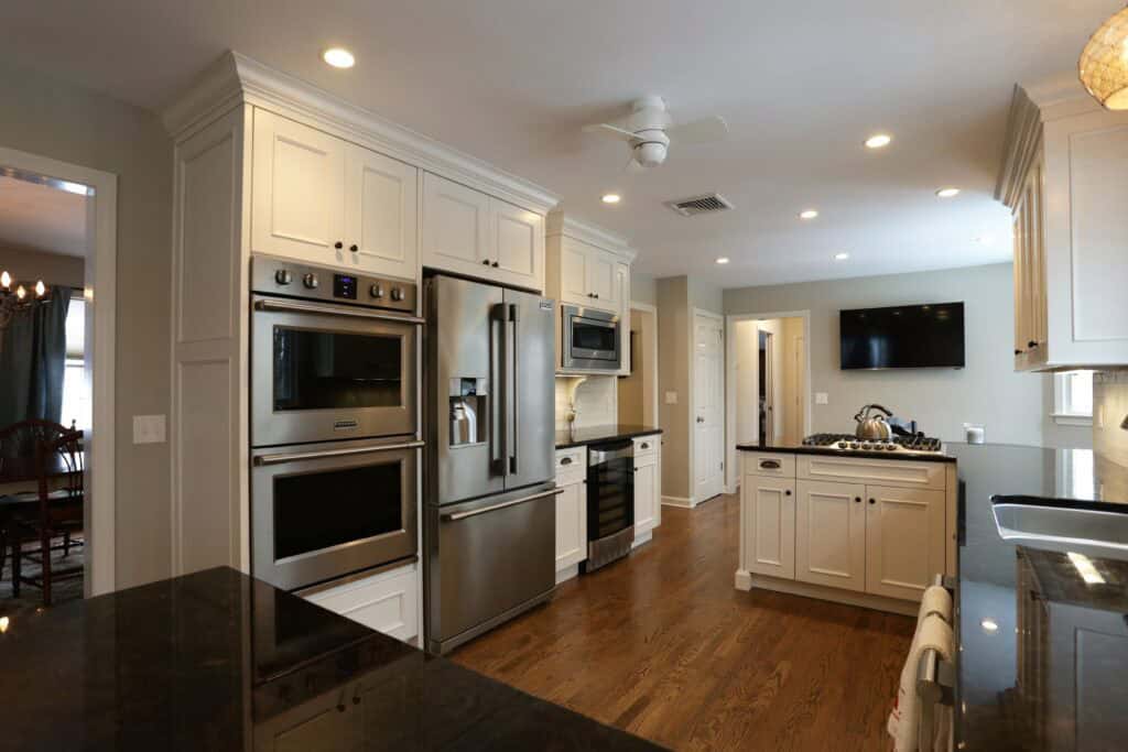 Bright, modern kitchen with stainless steel appliances and white cabinetry.
