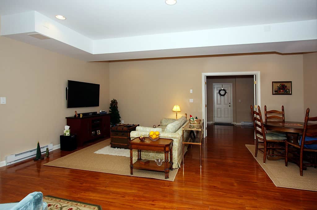 Spacious living room featuring a comfortable sofa, flat-screen TV, and warm lighting for a welcoming.