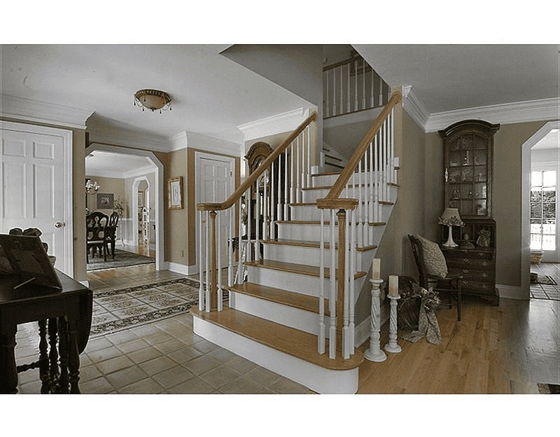 Beautiful interior staircase with wooden handrails and white spindles in a modern home.