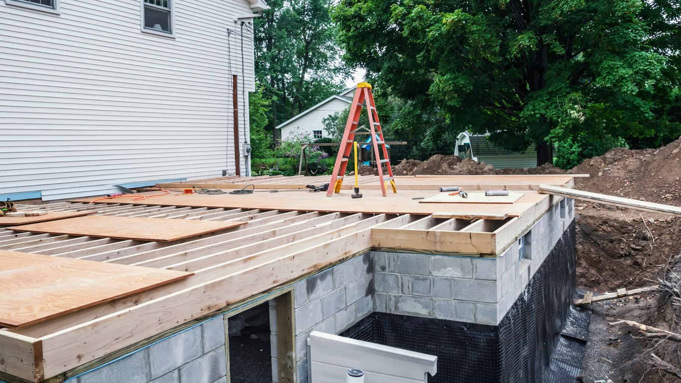 Construction deck framing in progress at a residential site.