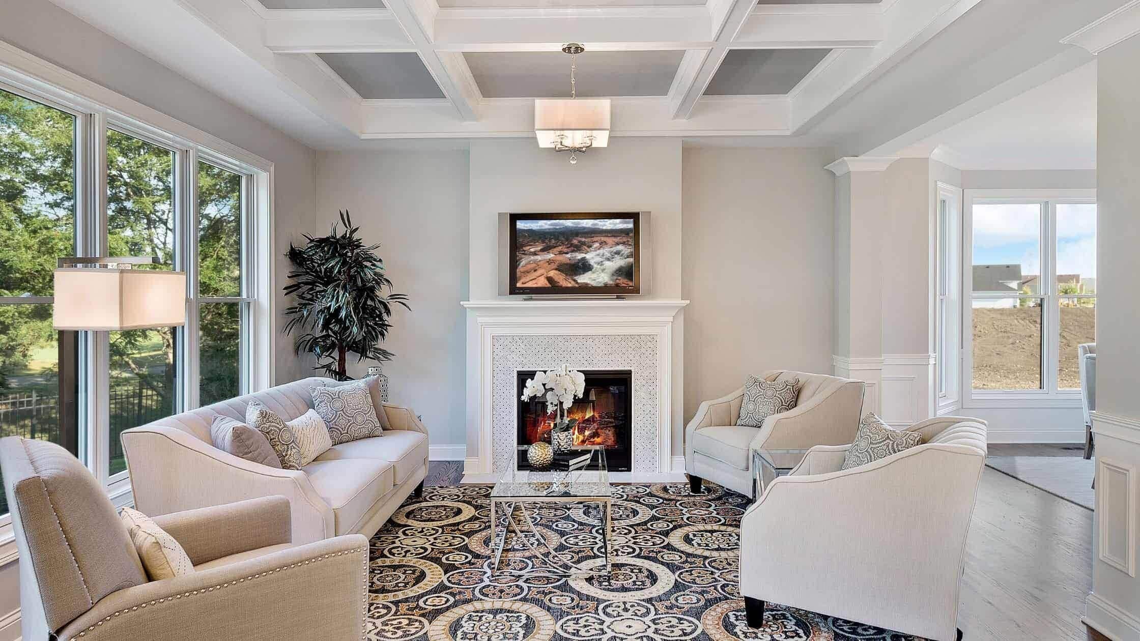 Elegant living room with fireplace, large windows, and comfortable seating.