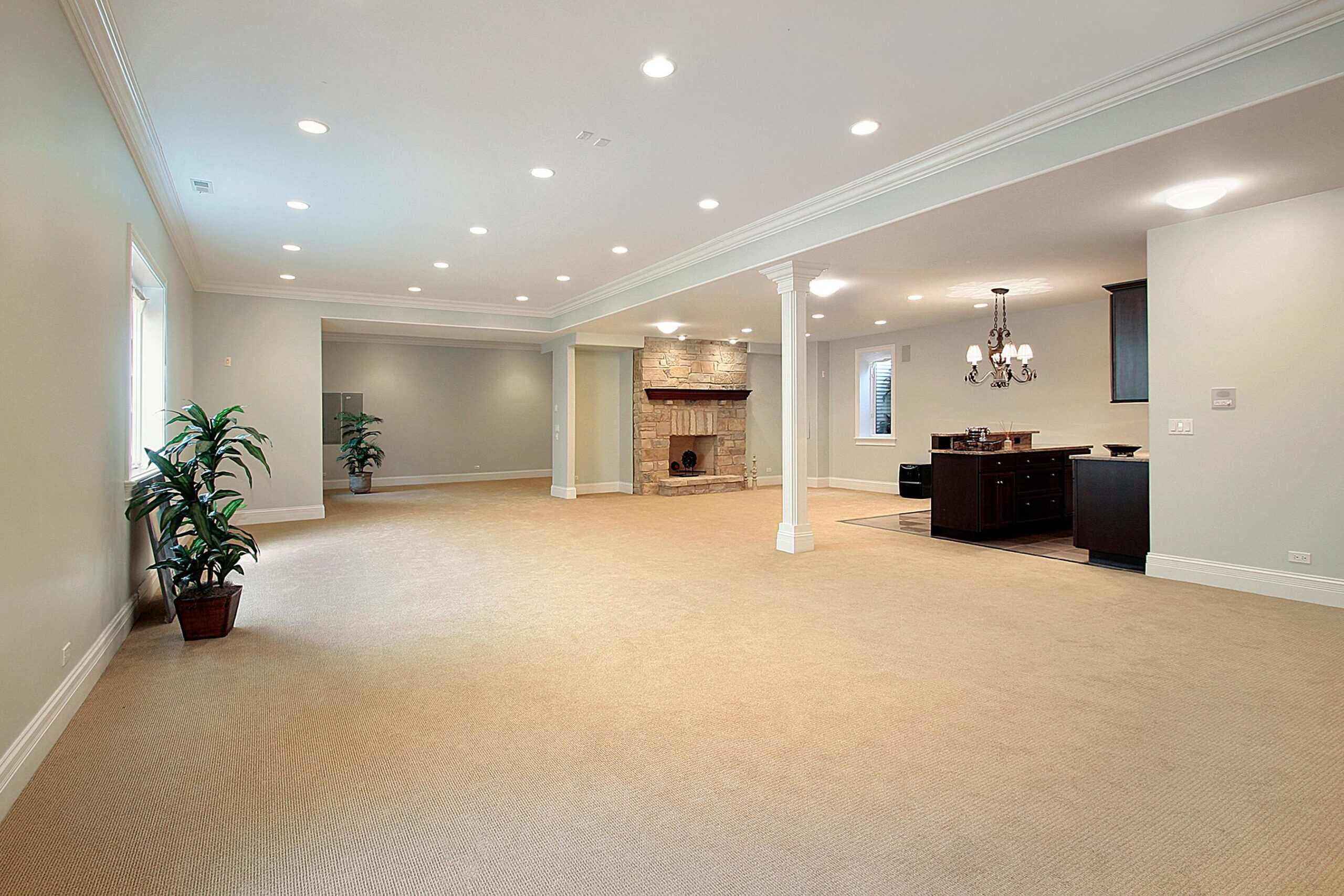 Bright spacious living room with fireplace and open kitchen area.